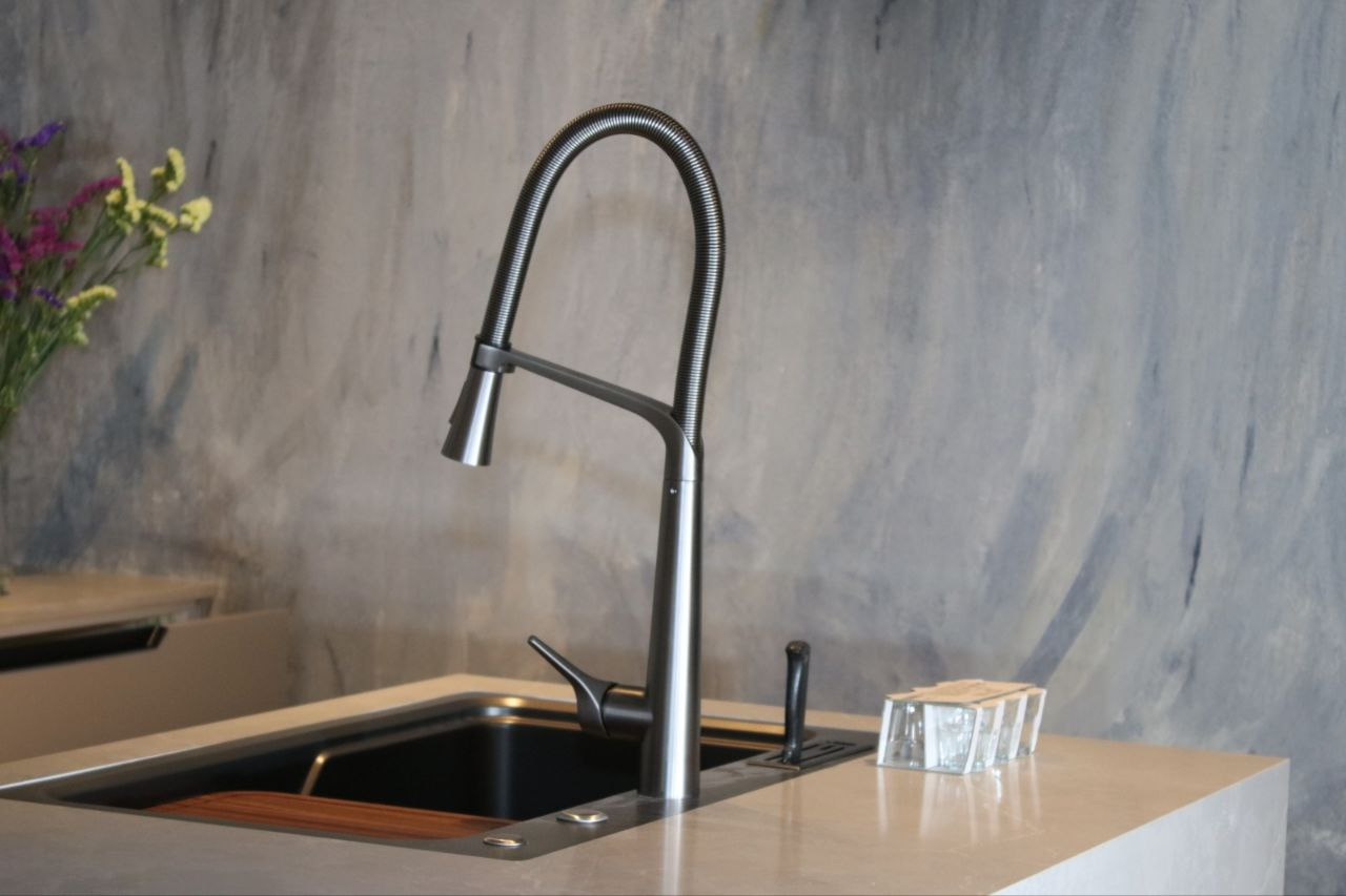 Modern kitchen renovation with quartz countertop and glass backsplash in a condominium unit in Orchard, designed for 90% humidity conditions.