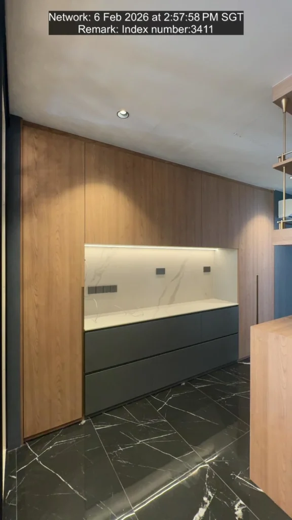 Tse7en modern kitchen with wood feature wall, gray base cabinets and white marble island