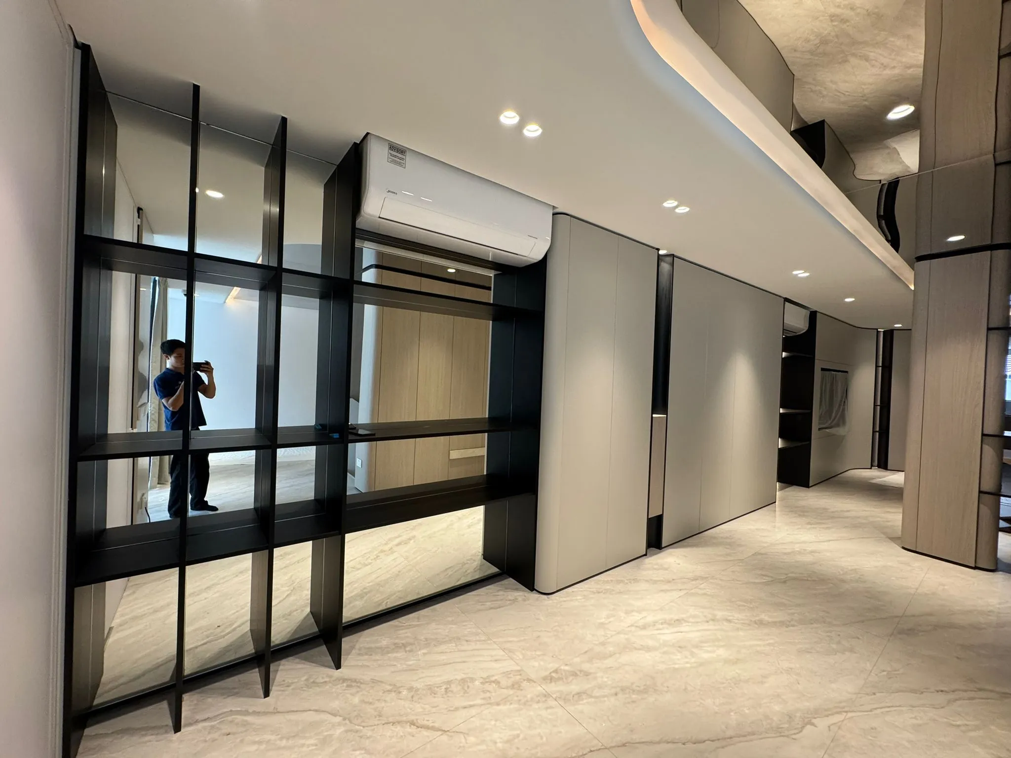 custom feature shelving and built-in cabinetry in living room during full home renovation in Singapore