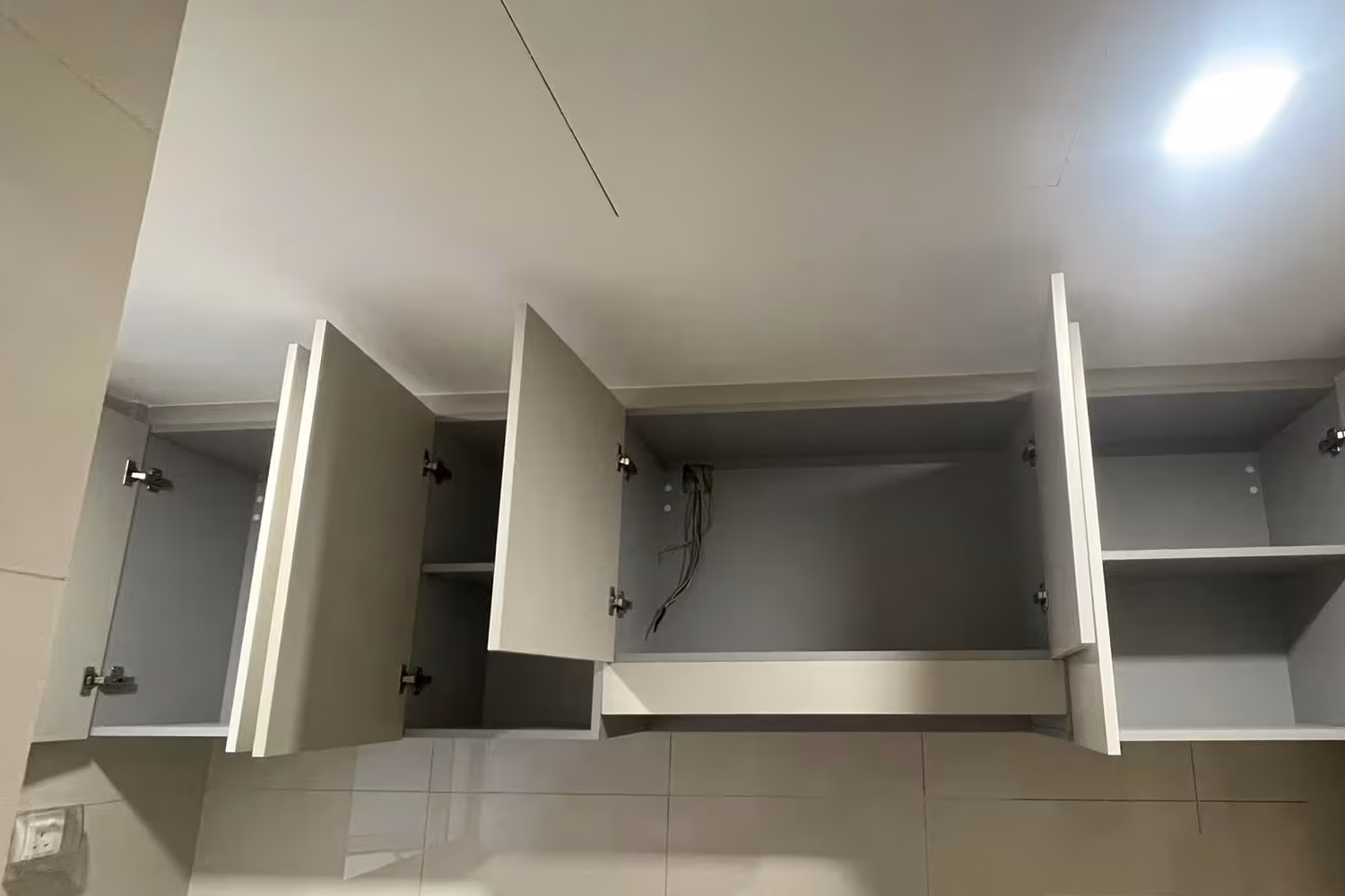 custom kitchen upper cabinets with built-in storage and minimalist modern design by T7Seven Singapore