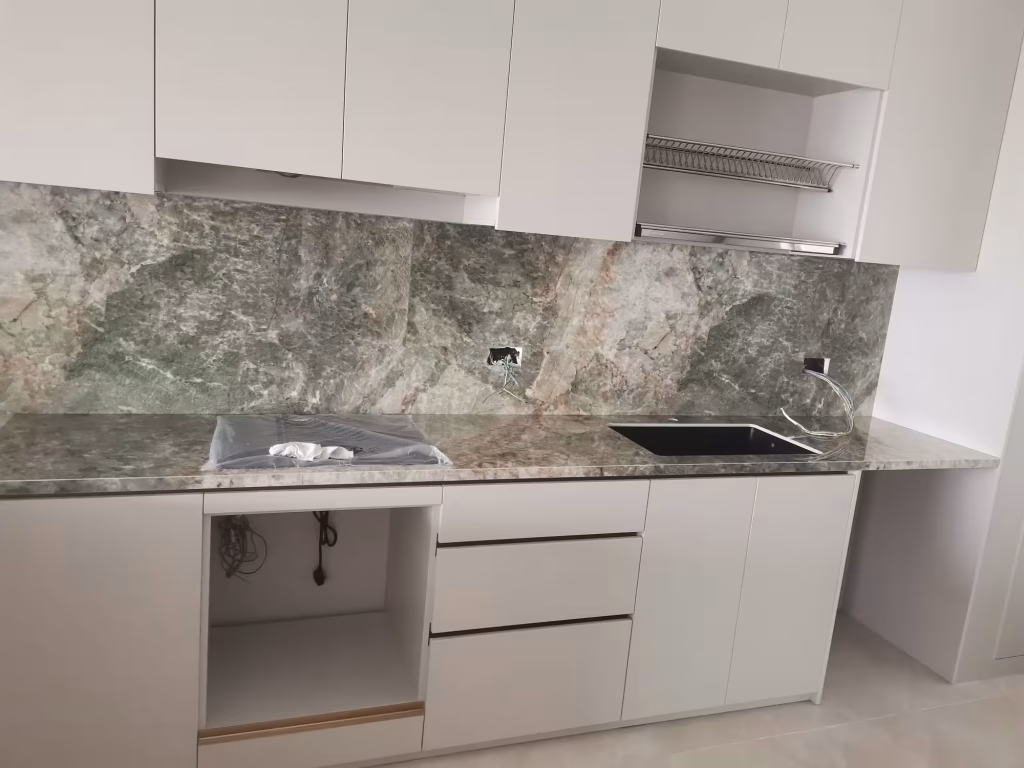 custom kitchen cabinetry with upper cabinets, stone backsplash, and integrated sink area by T7Seven Singapore