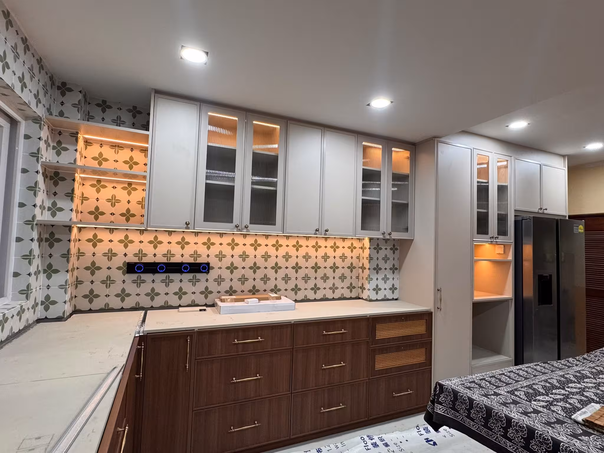 Tse7en modern display cabinet with illuminated arched fluted glass doors, upper wall cabinets, and wood storage drawers with decorative tile backsplash